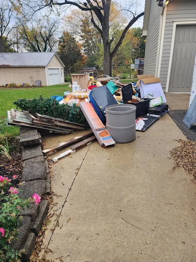 Dumpster being loaded with debris for Roofing Dumpster Rental in West Perrine